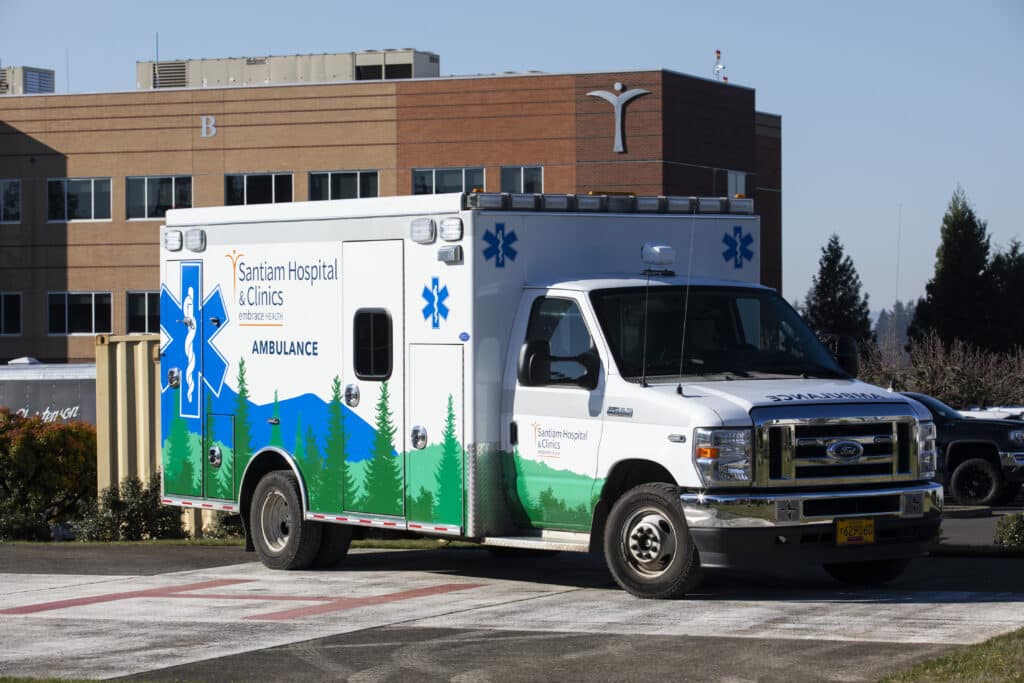 A Santiam Hospital & Clinics ambulance parked outside the hospital